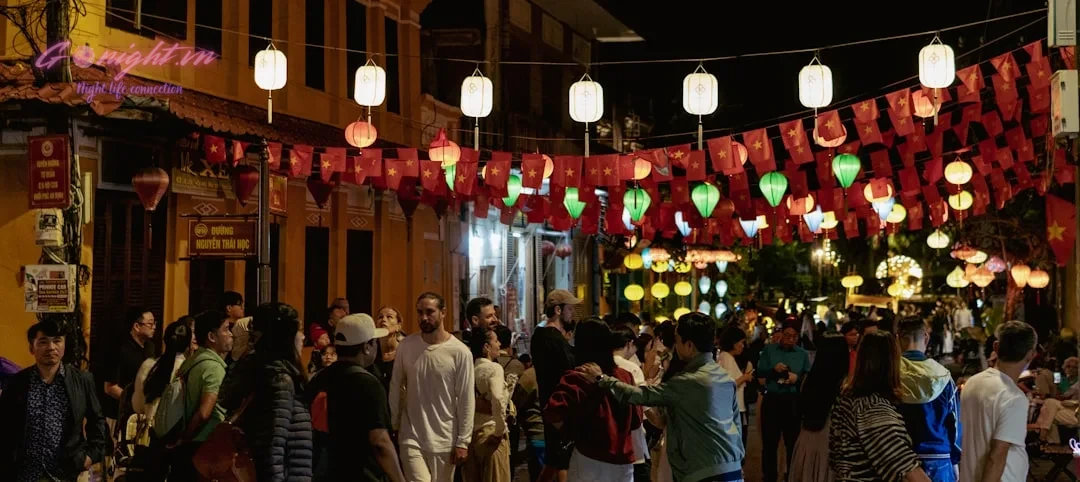 Essential Tips for First-Time International Travelers to Vietnam 1 Crowd walking down a street decorated with lanterns at night.