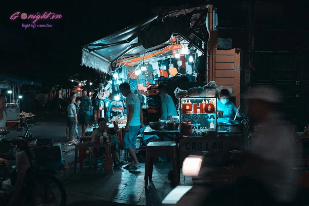 A group of people standing around a food truck