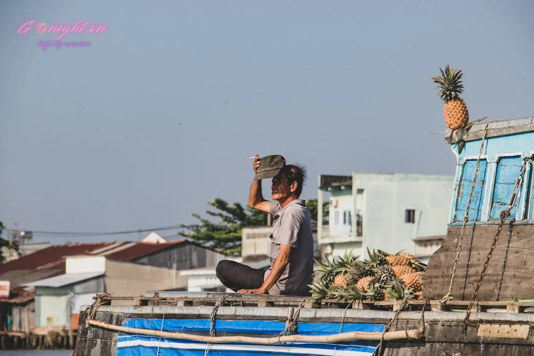 Vietnam's Craft Beer Scene: A Journey Through Local Brews and Top Beer Gardens 10 man in white t-shirt sitting on blue metal railings during daytime