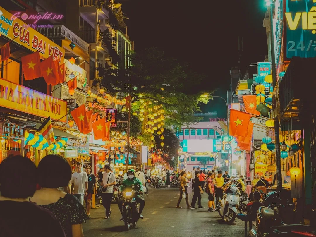 A bustling night scene in a vietnamese city.